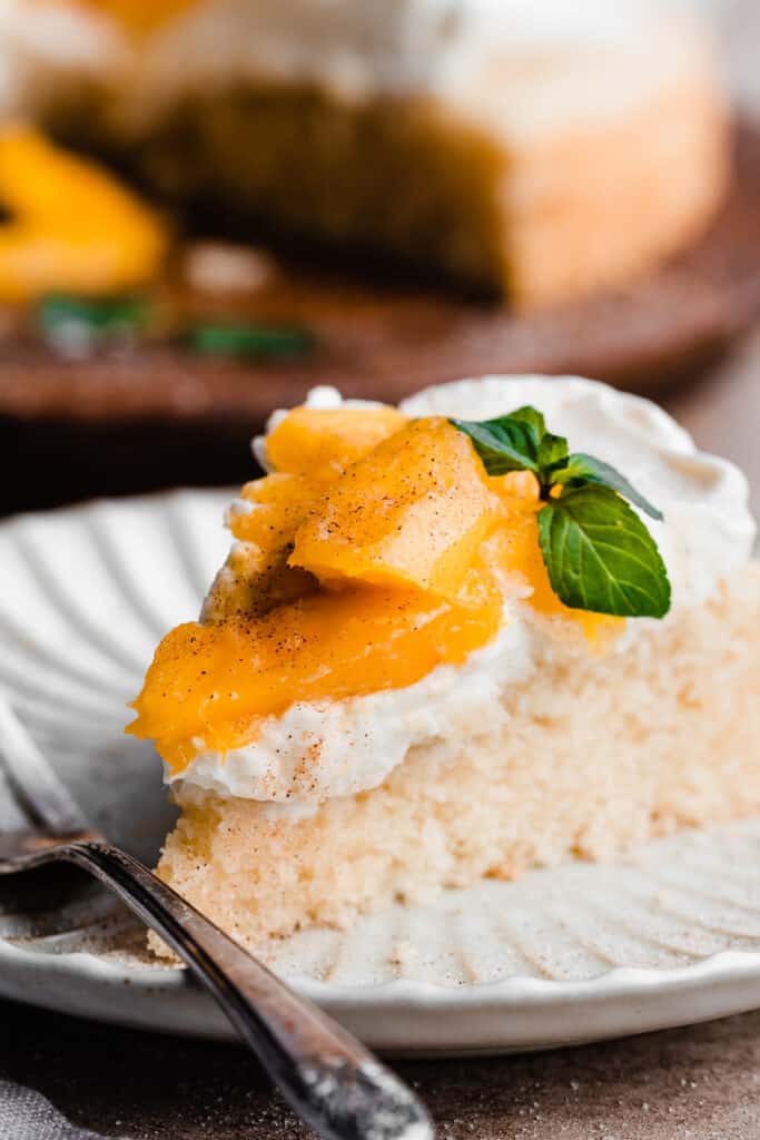 A slice of mango cake on a plate.
