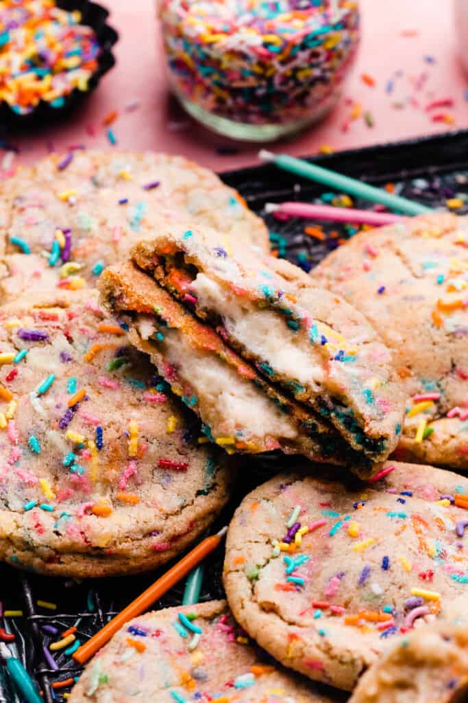A pile of funfetti cookies on a baking tray.