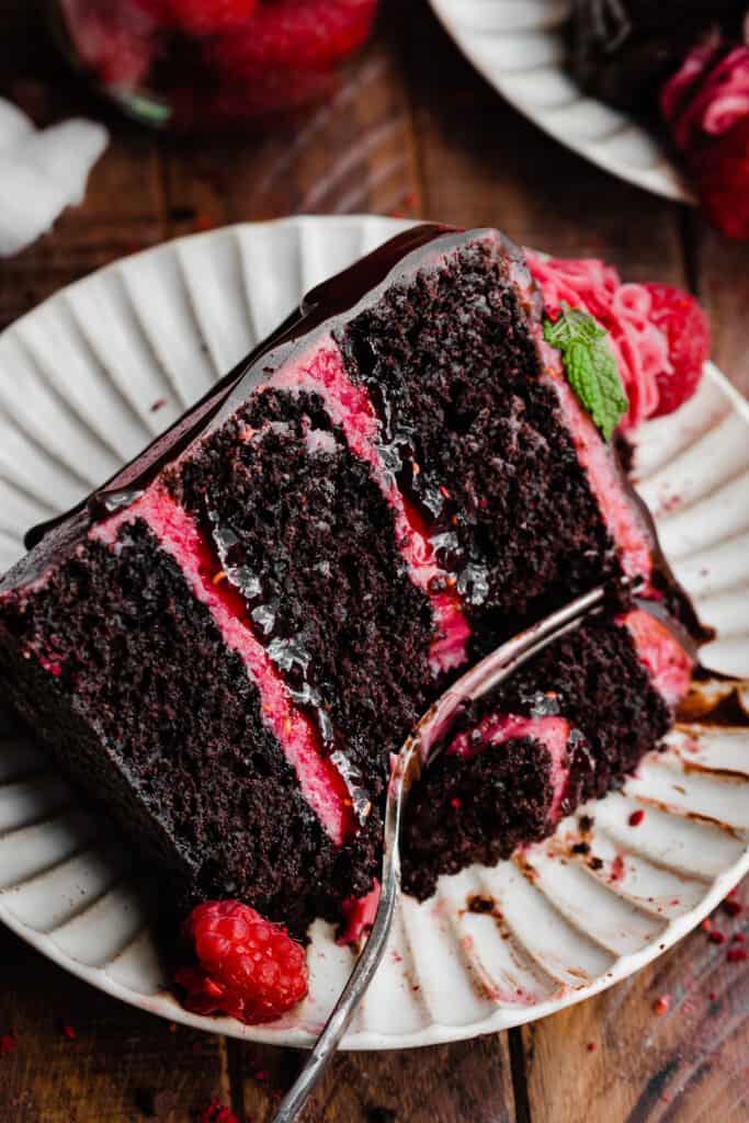 A top-down view of a slice of raspberry cake on a plate.