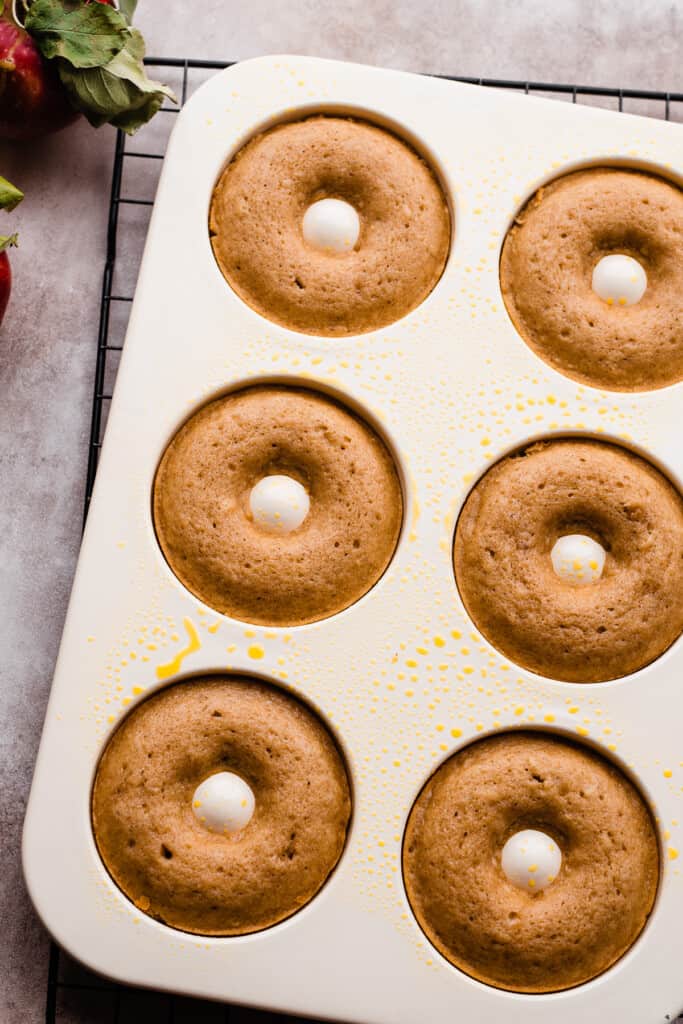 A donut pan with the baked donuts.