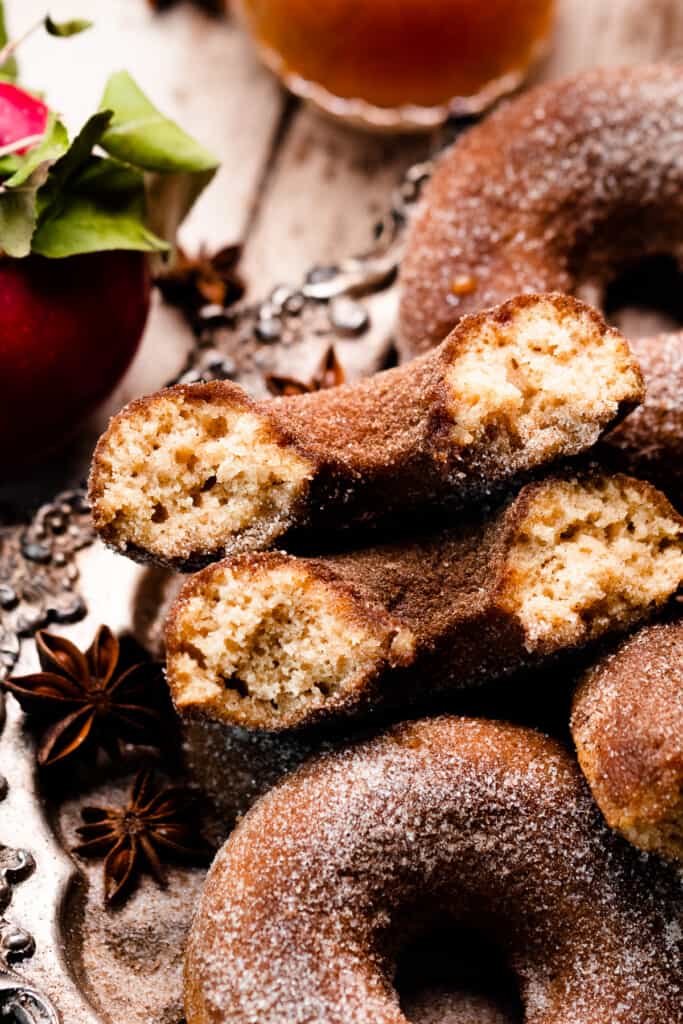 A close-up on two halves of an apple cider donut, showing the fluffy insides.