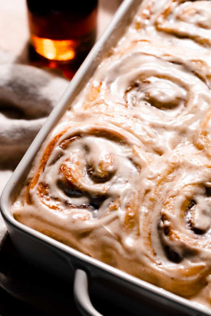 Frosted cinnamon rolls in the pan.