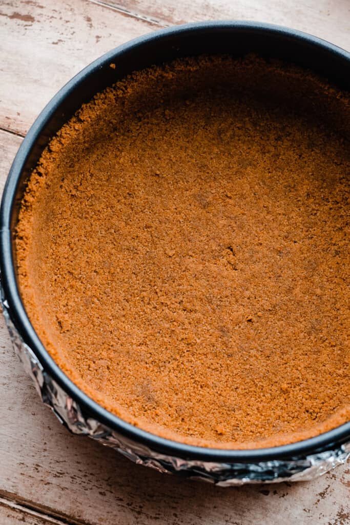 The baked cinnamon crust in a springform pan.