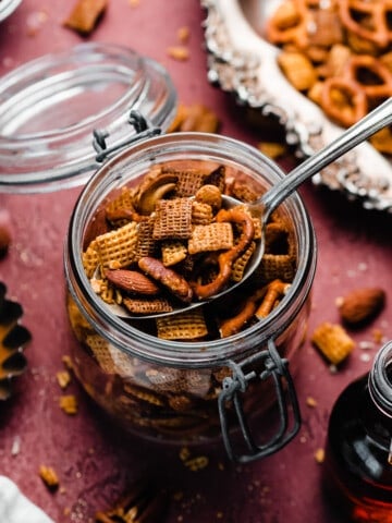 A jar of the maple chex on a burgundy backdrop.