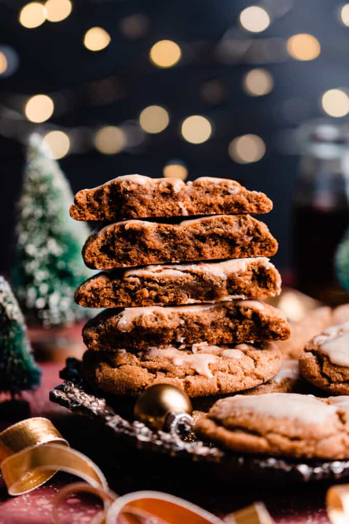 A wide angle photo of the stacked cookies with a backdrop of twinkling lights.