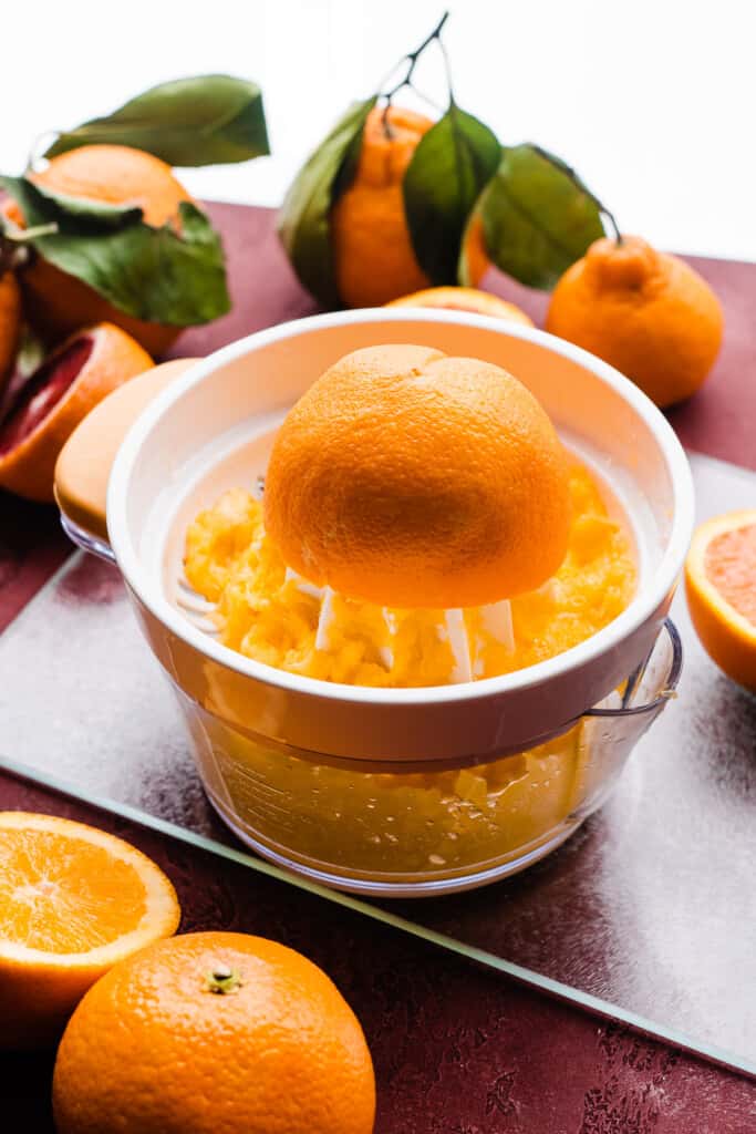 Oranges being juiced.