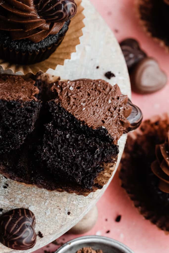 A sliced open chocolate cupcake, showing the fluffy & moist insides. 