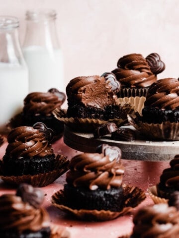 Frosted chocolate cupcakes on a cake stand.