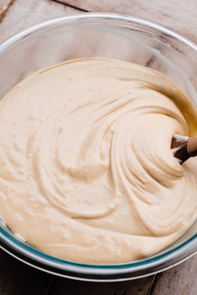 A bowl of silky caramel cheesecake batter.