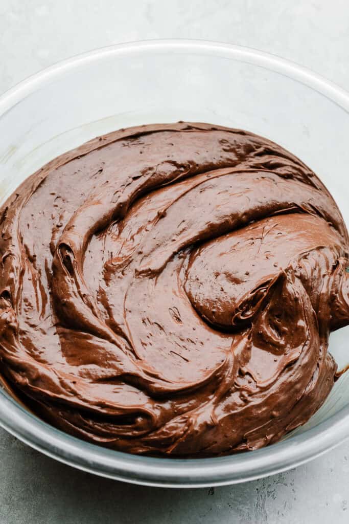 A bowl of creamy chocolate cheesecake batter.
