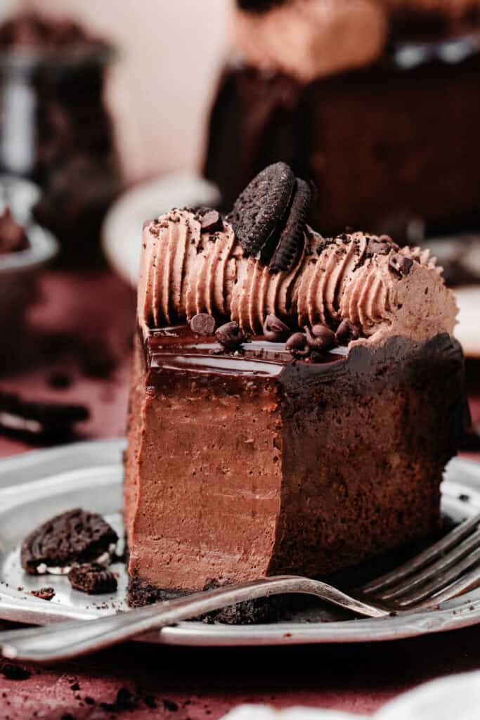 A close-up on a slice of the cheesecake, with bites missing.