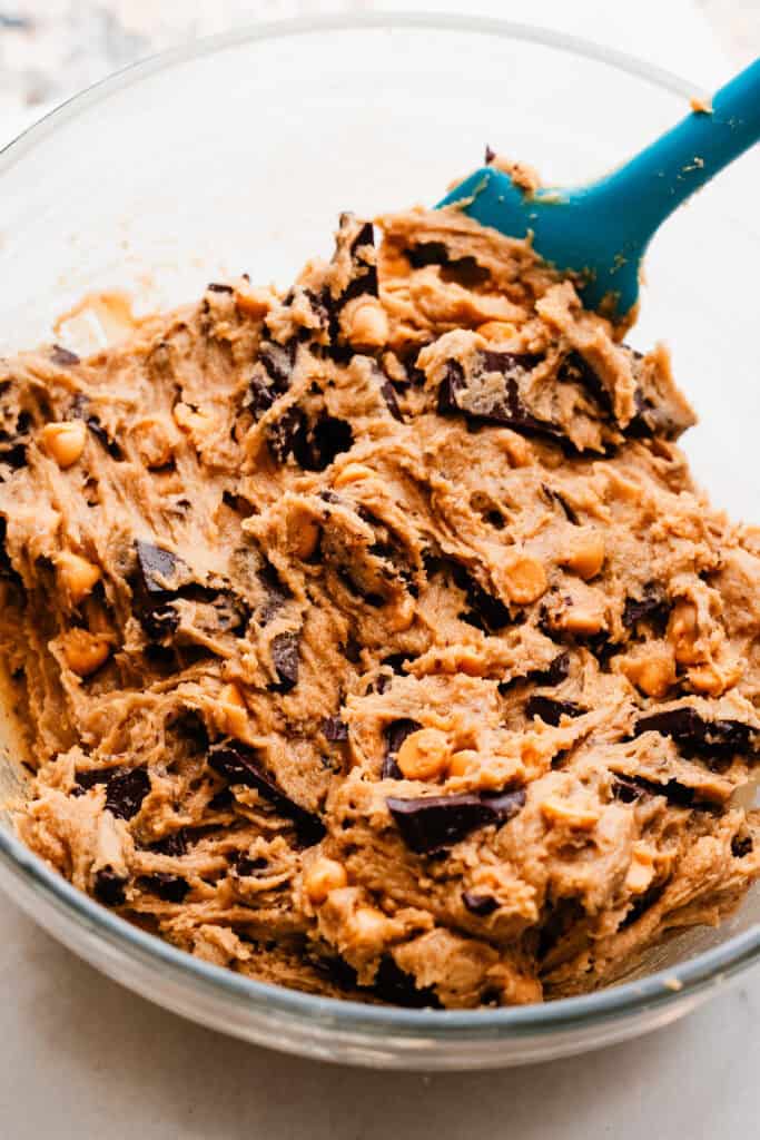 A bowl of the cookie dough, with all the chocolate and butterscotch added.