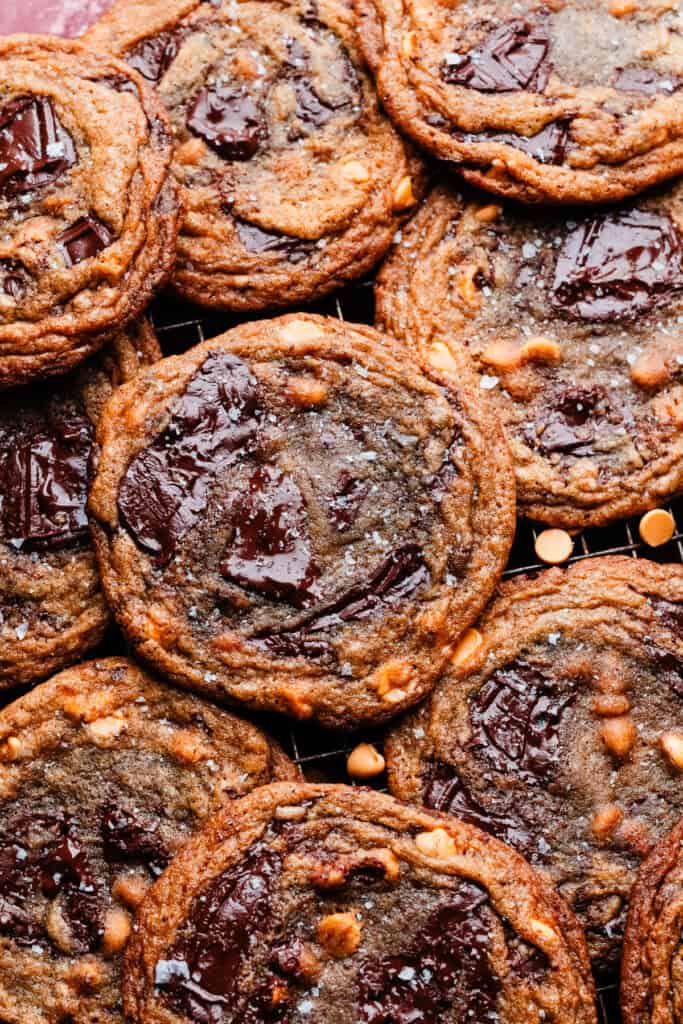 A close-up on the large, thin, and ripple-edged cookies on a cooling rack.