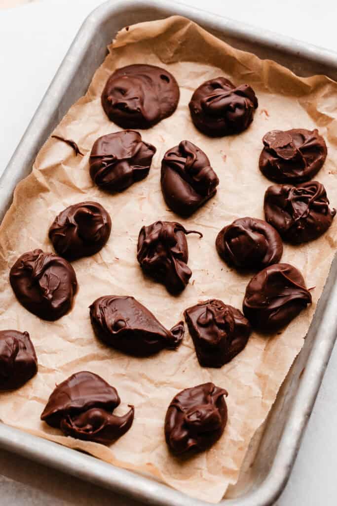 Frozen dollops of nutella on a tiny baking sheet.