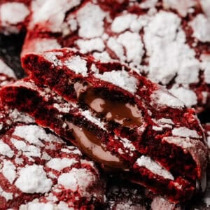 Two halves of a red velvet lava cookie, showing the molten nutella center inside.