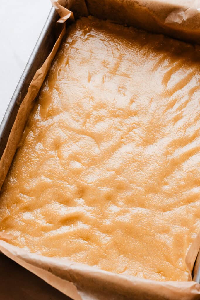 The crust mixture, pressed into a 9x13 pan and ready to be baked.