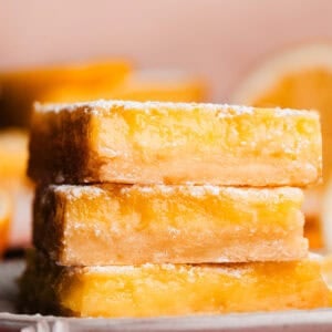 A stack of three luscious lemon bars on a plate.